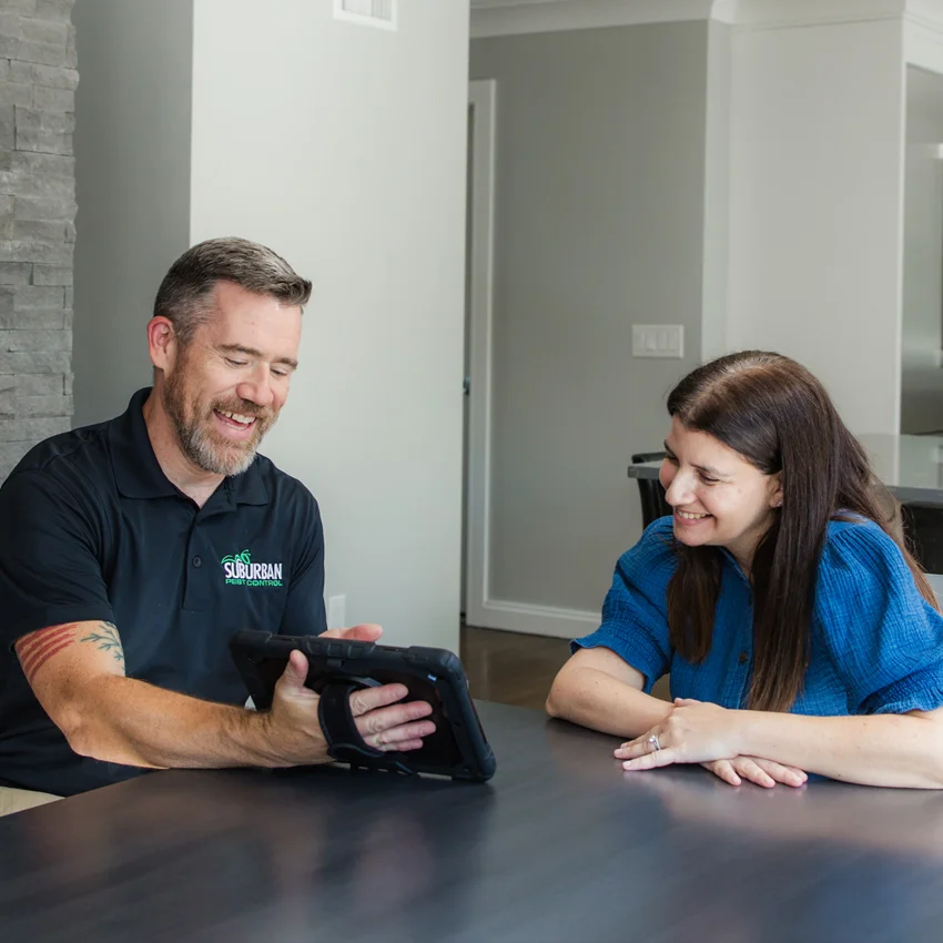 Suburban Pest technician speaking with a customer