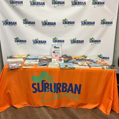 A Suburban Pest Control table with books on it